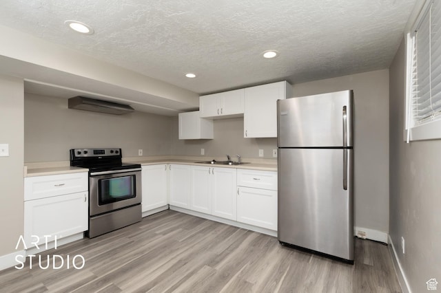 45 N 900 W, Provo, UT 84601 - kitchen featuring stainless steel appliances, light wood-style flooring, light countertops, white cabinets, and a textured ceiling