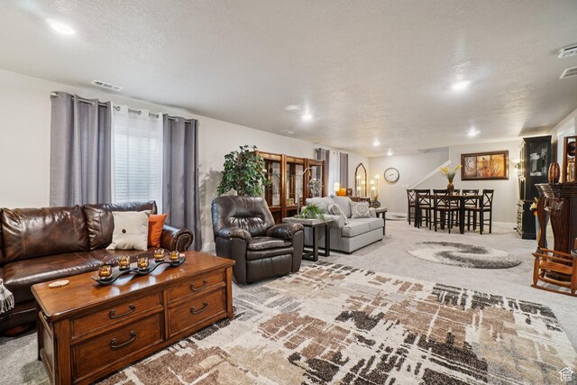 287 S Hayes Well Ln, Saratoga Springs, UT 84045 - carpeted living area with a textured ceiling