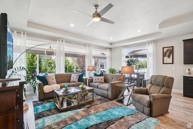 287 S Hayes Well Ln, Saratoga Springs, UT 84045 - living area with a tray ceiling, light wood-style flooring, a ceiling fan, recessed lighting, and a textured ceiling
