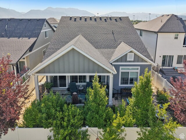 287 S Hayes Well Ln, Saratoga Springs, UT 84045 - view of front of property featuring roof with shingles, board and batten siding, a mountain view, and a fenced backyard