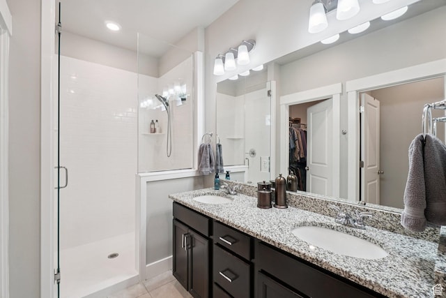 287 S Hayes Well Ln, Saratoga Springs, UT 84045 - bathroom with a shower stall, a walk in closet, double vanity, and tile patterned flooring