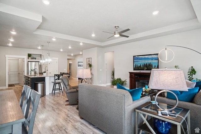 287 S Hayes Well Ln, Saratoga Springs, UT 84045 - living room with a raised ceiling, light wood-style flooring, a ceiling fan, and recessed lighting