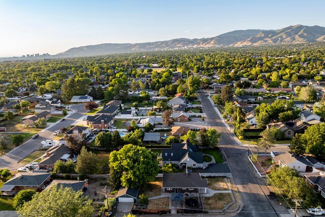 3076 S Melbourne St, Millcreek, UT 84106 - aerial overview of property's location with a mountain backdrop and nearby suburban area