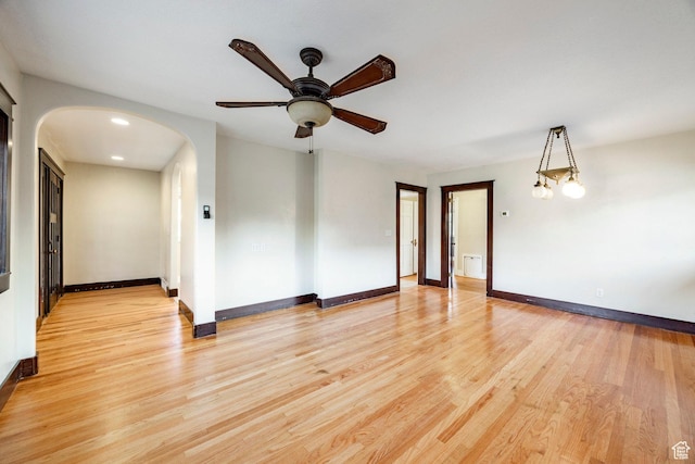 3076 S Melbourne St, Millcreek, UT 84106 - spare room with arched walkways, a ceiling fan, and light wood-style floors