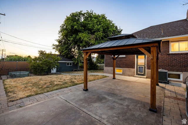 3076 S Melbourne St, Millcreek, UT 84106 - patio terrace at dusk featuring a patio area and a gazebo
