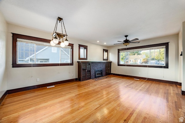 3076 S Melbourne St, Millcreek, UT 84106 - unfurnished living room with light wood-style floors, a fireplace, ceiling fan, and recessed lighting