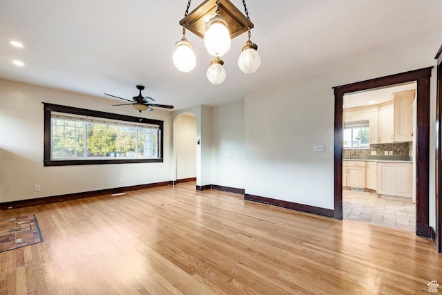 3076 S Melbourne St, Millcreek, UT 84106 - spare room with arched walkways, light wood finished floors, and a ceiling fan