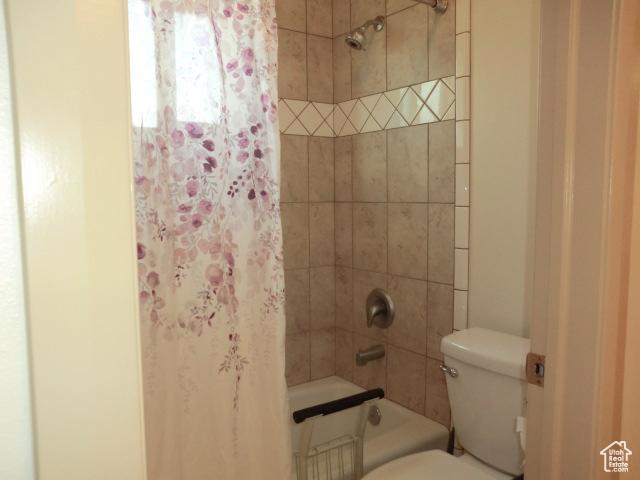 320 S 1125 W, Parowan, UT 84761 - bathroom featuring toilet and shower / tub combo with curtain