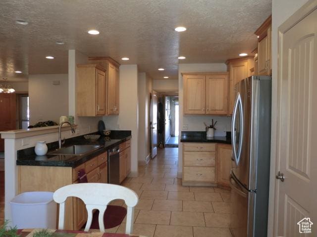 320 S 1125 W, Parowan, UT 84761 - kitchen with appliances with stainless steel finishes, light brown cabinets, a textured ceiling, a peninsula, and recessed lighting