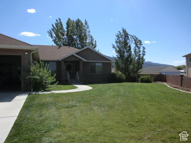 320 S 1125 W, Parowan, UT 84761 - ranch-style home featuring concrete driveway and an attached garage