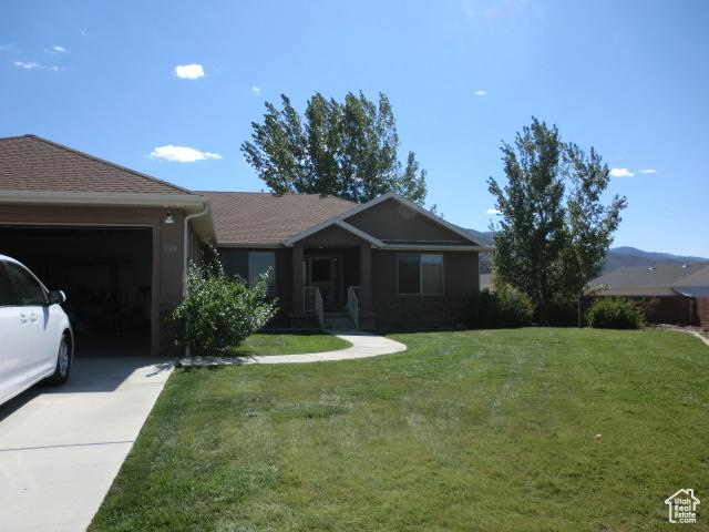 320 S 1125 W, Parowan, UT 84761 - ranch-style house featuring concrete driveway, a garage, and a front lawn