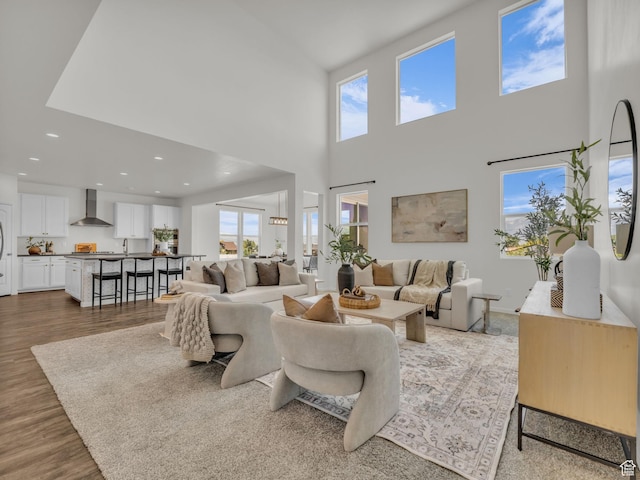 13249 S Shearing Cv, Herriman, UT 84096 - living area with a towering ceiling, wood finished floors, and recessed lighting