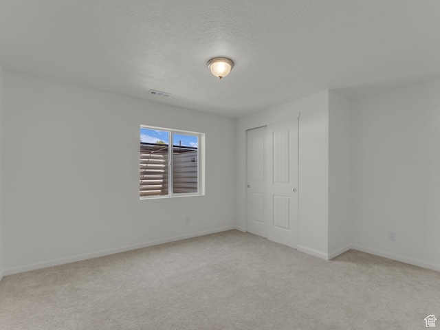 13249 S Shearing Cv, Herriman, UT 84096 - unfurnished bedroom with carpet, a textured ceiling, and a closet