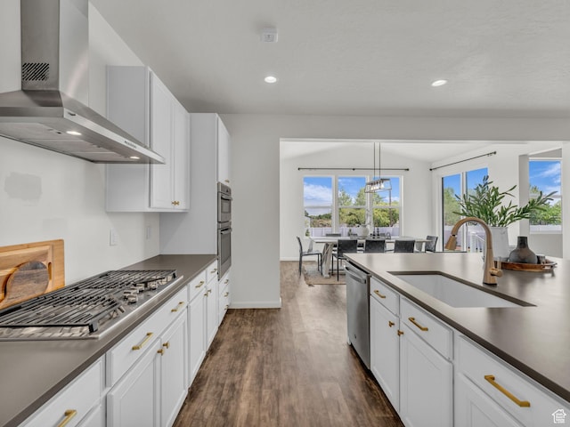 13249 S Shearing Cv, Herriman, UT 84096 - kitchen featuring wall chimney range hood, stainless steel appliances, dark countertops, dark wood-style flooring, and white cabinetry