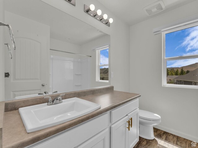 13249 S Shearing Cv, Herriman, UT 84096 - bathroom featuring vanity, wood finished floors, and a shower