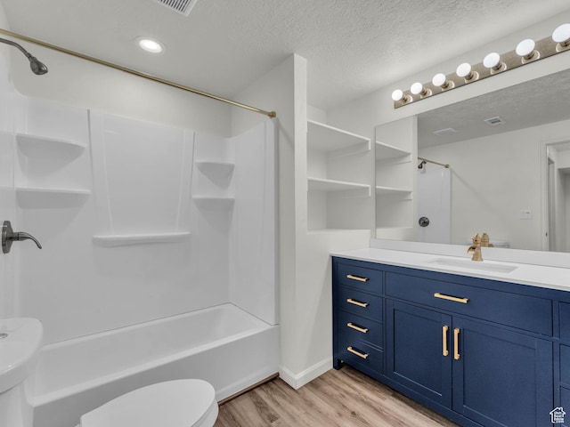 13249 S Shearing Cv, Herriman, UT 84096 - full bath with wood finished floors, shower / bath combination, vanity, recessed lighting, and a textured ceiling