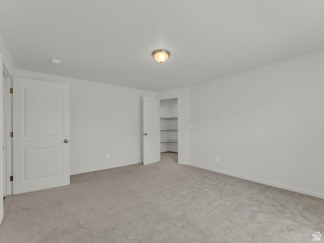 13249 S Shearing Cv, Herriman, UT 84096 - unfurnished bedroom featuring light colored carpet and a walk in closet
