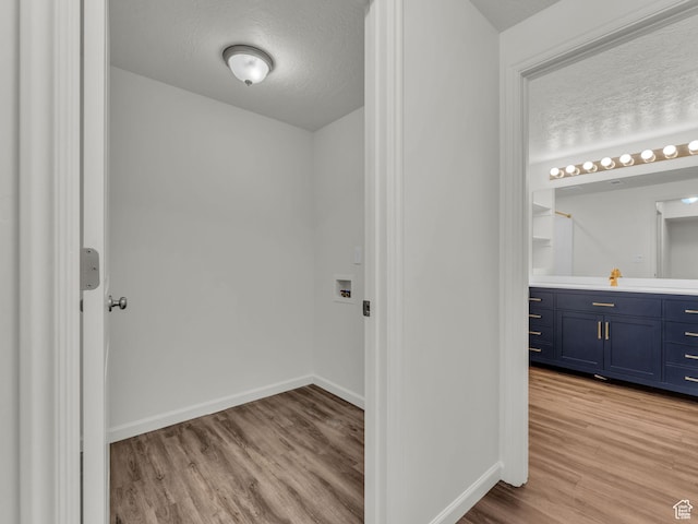 13249 S Shearing Cv, Herriman, UT 84096 - washroom featuring light wood-style flooring and hookup for a washing machine