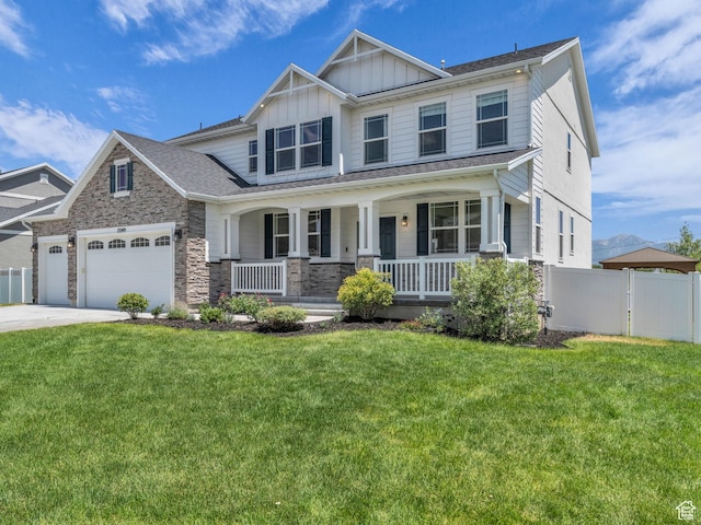 13249 S Shearing Cv, Herriman, UT 84096 - craftsman house featuring covered porch, an attached garage, stone siding, board and batten siding, and concrete driveway