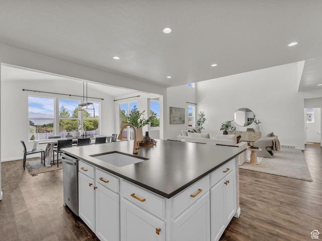 13249 S Shearing Cv, Herriman, UT 84096 - kitchen featuring open floor plan, recessed lighting, dark wood finished floors, stainless steel dishwasher, and a center island with sink