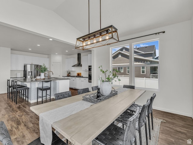 13249 S Shearing Cv, Herriman, UT 84096 - dining area featuring dark wood-type flooring, vaulted ceiling, recessed lighting, and a chandelier