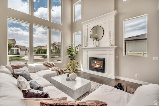 11531 S 840 W, Draper, UT 84020 - living area featuring dark wood-type flooring, a glass covered fireplace, and a towering ceiling