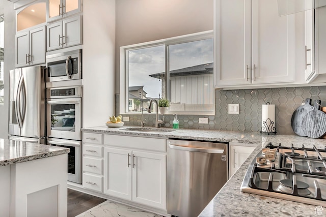 11531 S 840 W, Draper, UT 84020 - kitchen featuring stainless steel appliances, white cabinetry, tasteful backsplash, and glass insert cabinets