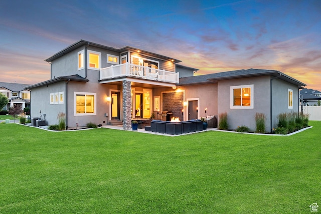 11531 S 840 W, Draper, UT 84020 - back of property at dusk with a balcony, stucco siding, a yard, and a patio area
