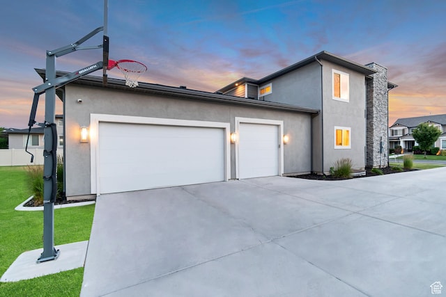 11531 S 840 W, Draper, UT 84020 - view of front of home with driveway, an attached garage, stucco siding, and a yard