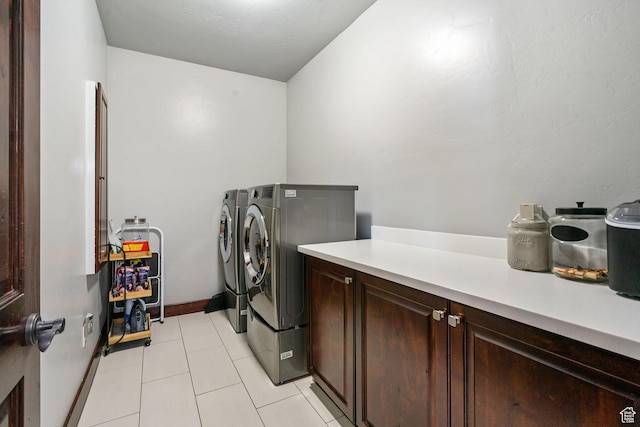 5584 N Gentle Breeze Ct, Stansbury Park, UT 84074 - laundry room featuring cabinet space, independent washer and dryer, and light tile patterned floors