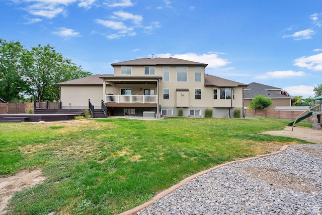 5584 N Gentle Breeze Ct, Stansbury Park, UT 84074 - back of property featuring stucco siding, a playground, and a wooden deck