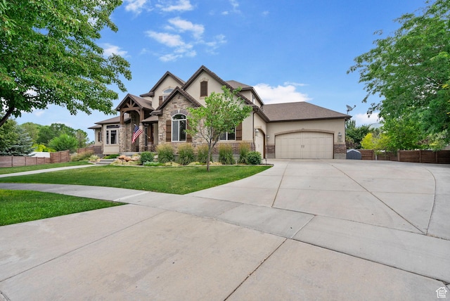 5584 N Gentle Breeze Ct, Stansbury Park, UT 84074 - view of front of house featuring stone siding, stucco siding, an attached garage, and driveway