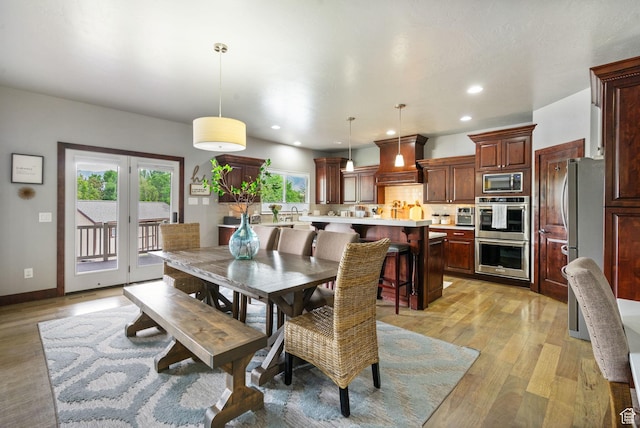 5584 N Gentle Breeze Ct, Stansbury Park, UT 84074 - dining space with light wood finished floors and recessed lighting