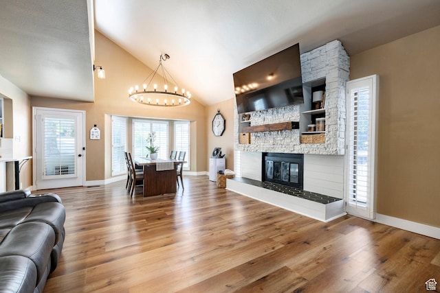 534 E 1400th St S, Bountiful, UT 84010 - living area featuring a chandelier, wood finished floors, built in features, a fireplace, and high vaulted ceiling