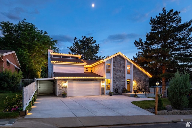 534 E 1400th St S, Bountiful, UT 84010 - view of front of home featuring stone siding, driveway, a chimney, and an attached garage