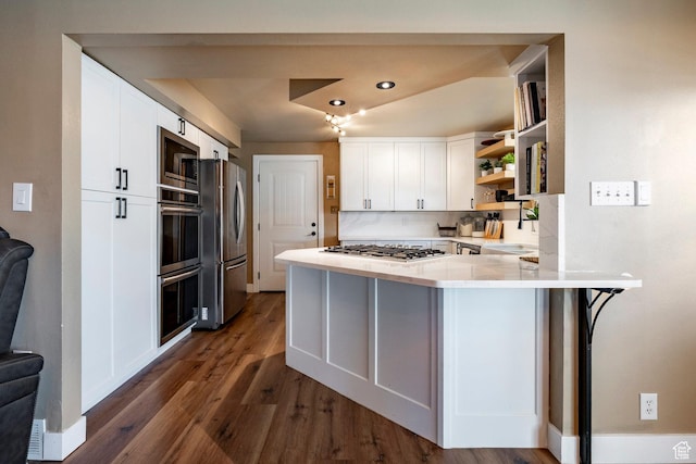 534 E 1400th St S, Bountiful, UT 84010 - kitchen featuring appliances with stainless steel finishes, open shelves, a peninsula, dark wood-style floors, and white cabinetry