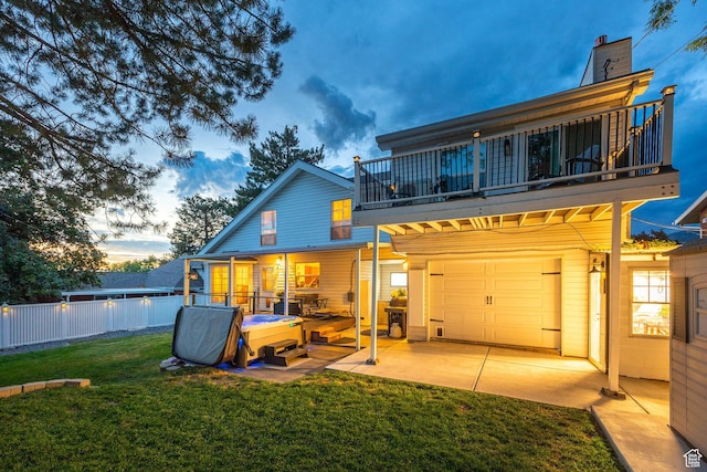 534 E 1400th St S, Bountiful, UT 84010 - back of house at dusk with a balcony and an attached garage
