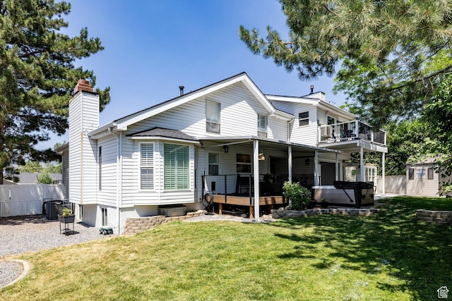 534 E 1400th St S, Bountiful, UT 84010 - back of property featuring a chimney, a hot tub, and a wooden deck