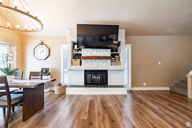 534 E 1400th St S, Bountiful, UT 84010 - living area featuring wood finished floors, stairway, a chandelier, and a fireplace