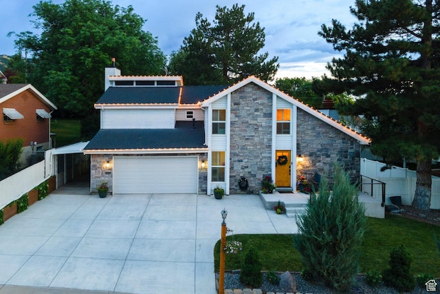 534 E 1400th St S, Bountiful, UT 84010 - view of front of home featuring stone siding, concrete driveway, and a garage