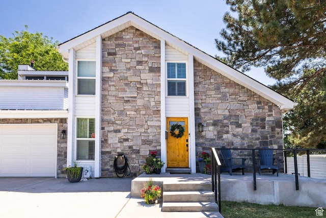 534 E 1400th St S, Bountiful, UT 84010 - view of front of home with stone siding, a garage, and concrete driveway