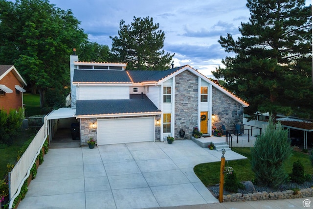 534 E 1400th St S, Bountiful, UT 84010 - view of front of property with stone siding, a chimney, concrete driveway, and a garage