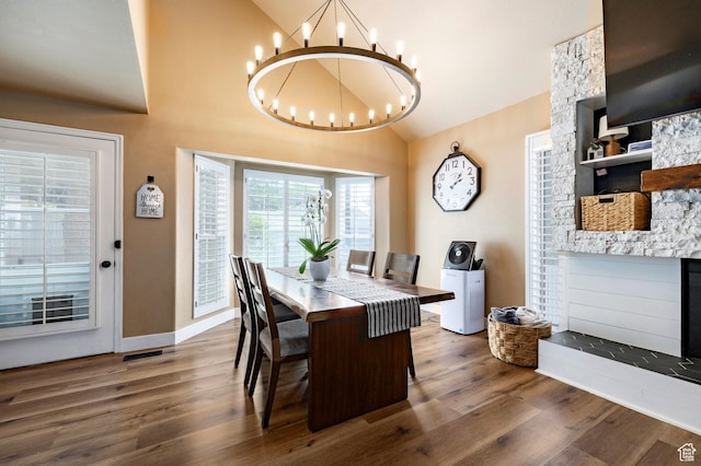 534 E 1400th St S, Bountiful, UT 84010 - dining space with a chandelier, wood finished floors, high vaulted ceiling, and a fireplace