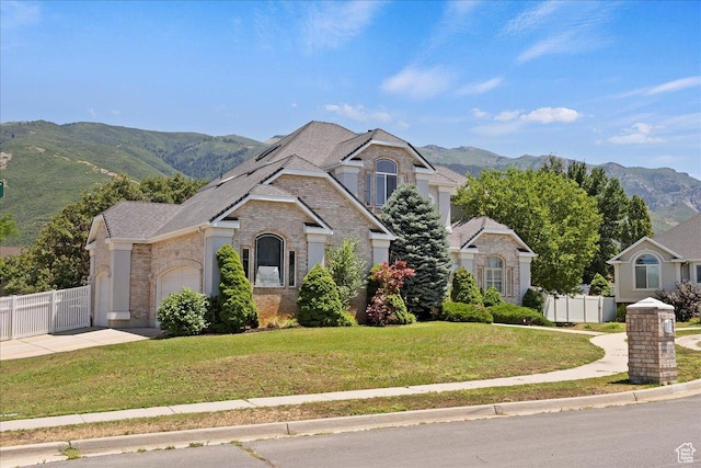 3680 N 2300 E, Layton, UT 84040 - view of front of house with brick siding, a mountain view, driveway, and a garage