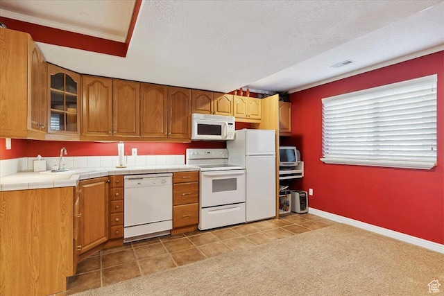 3680 N 2300 E, Layton, UT 84040 - kitchen with white appliances, glass insert cabinets, brown cabinetry, light tile patterned floors, and tile countertops