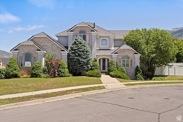 3680 N 2300 E, Layton, UT 84040 - traditional home featuring a front lawn, brick siding, and stucco siding