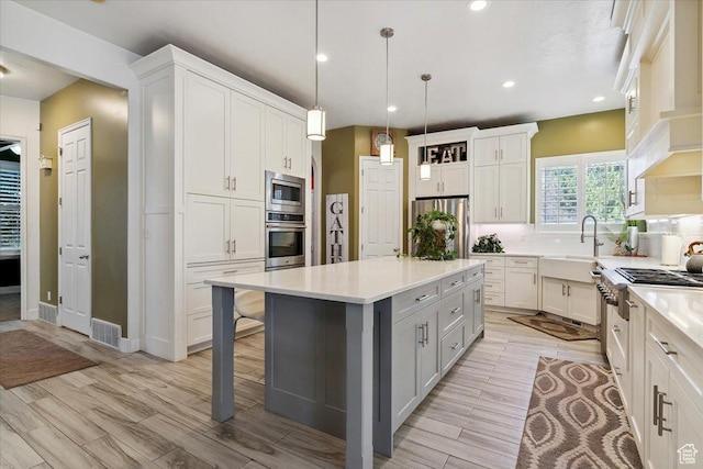 3680 N 2300 E, Layton, UT 84040 - kitchen featuring appliances with stainless steel finishes, light countertops, a breakfast bar area, recessed lighting, and backsplash