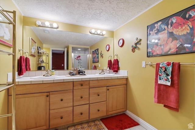 3680 N 2300 E, Layton, UT 84040 - bathroom featuring a textured ceiling, double vanity, crown molding, a shower with door, and tile patterned flooring