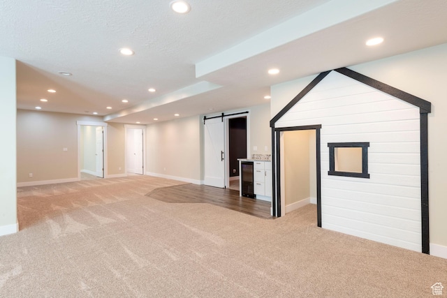 1233 S 2240 E, Heber City, UT 84032 - unfurnished living room with a barn door, light colored carpet, recessed lighting, and beverage cooler