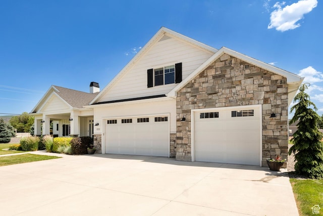 1233 S 2240 E, Heber City, UT 84032 - view of front of home featuring stone siding, concrete driveway, an attached garage, and a chimney